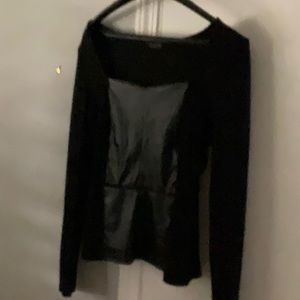 Long sleeves peplum style top with faux leather down front.